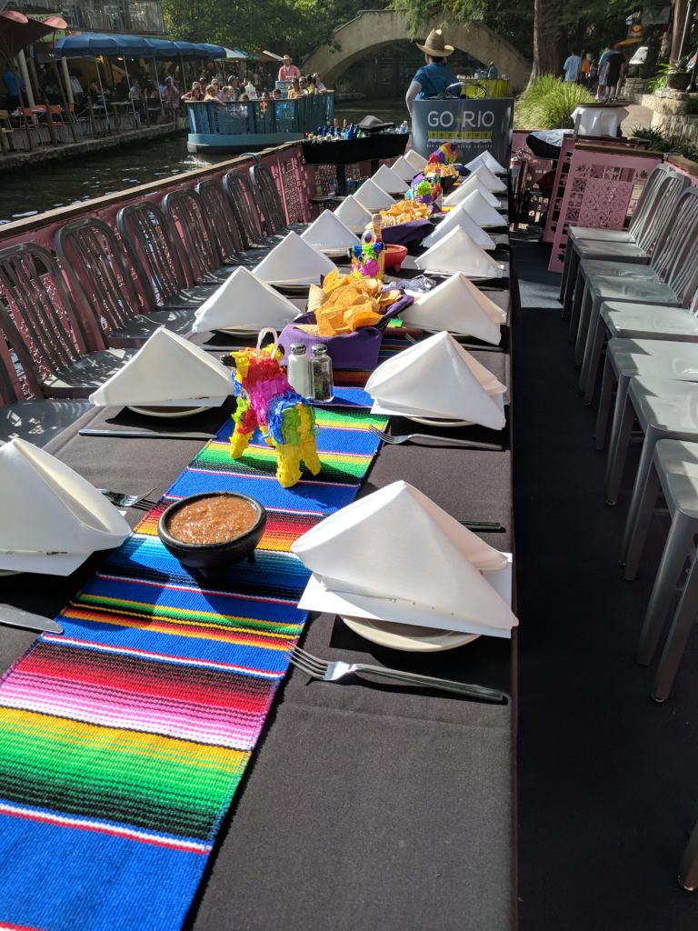 Table setup for a river barge party at Cafe Ole